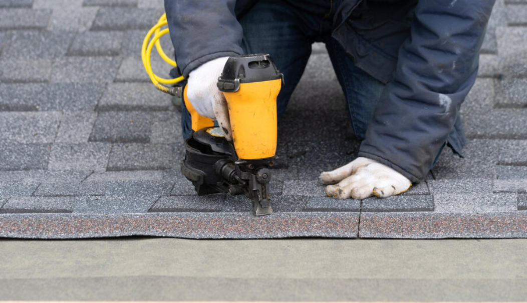 Commercial metal roofing in Kansas City – Murphy & Sons roofer at work on a roof