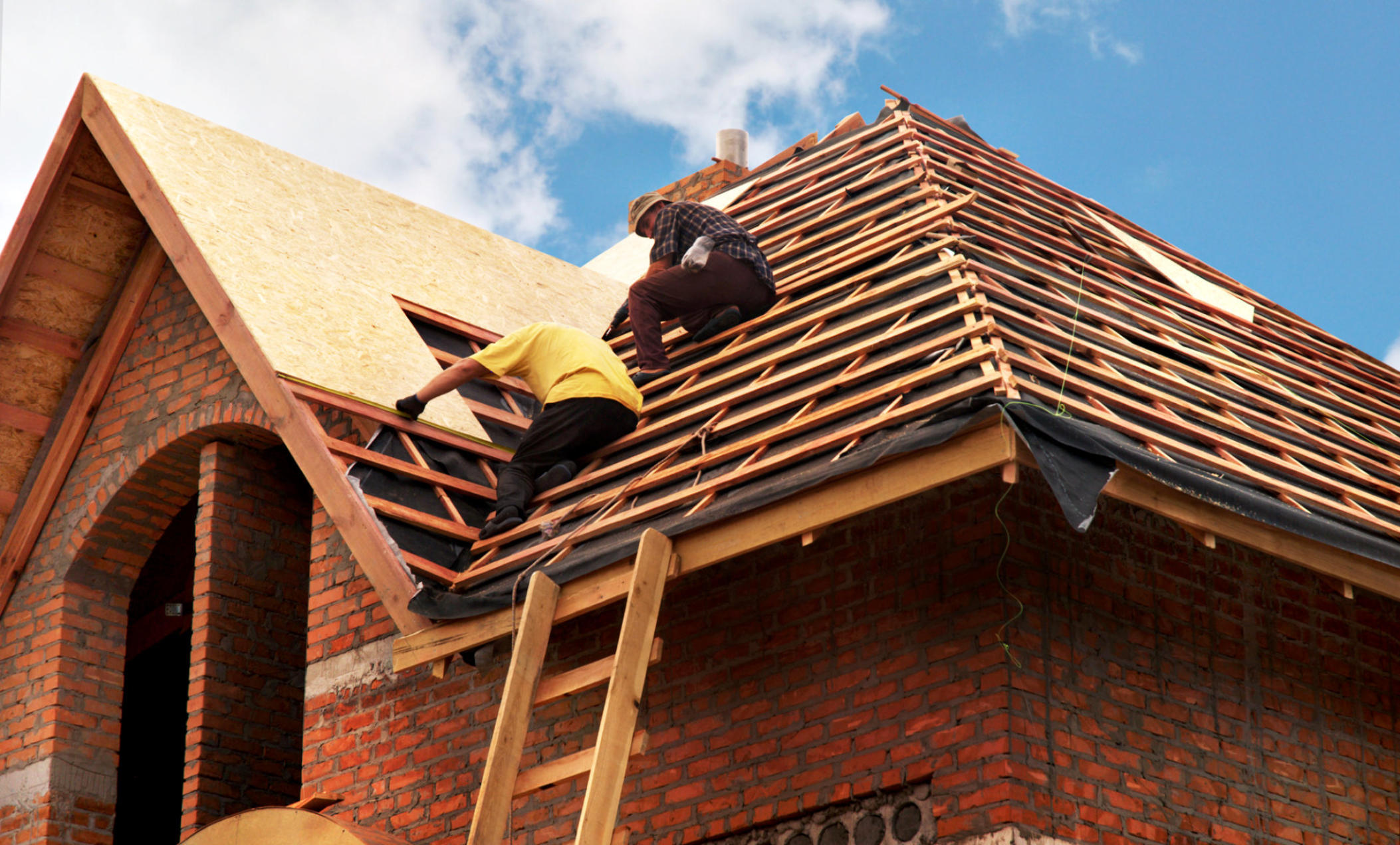 Storm restoration in Kansas City – Murphy & Sons crew rebuilding a home's roof
